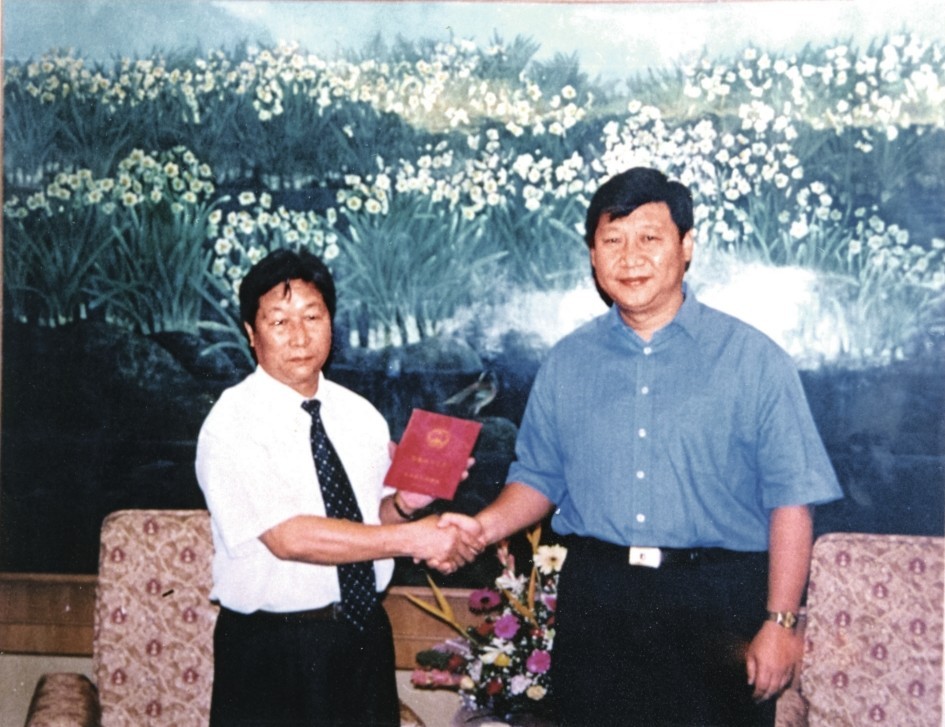 2000年7月，习近平为福建农林大学教授林占熺颁发福建省政府“一等功”荣誉证书。图源：《习近平在福建》（下）