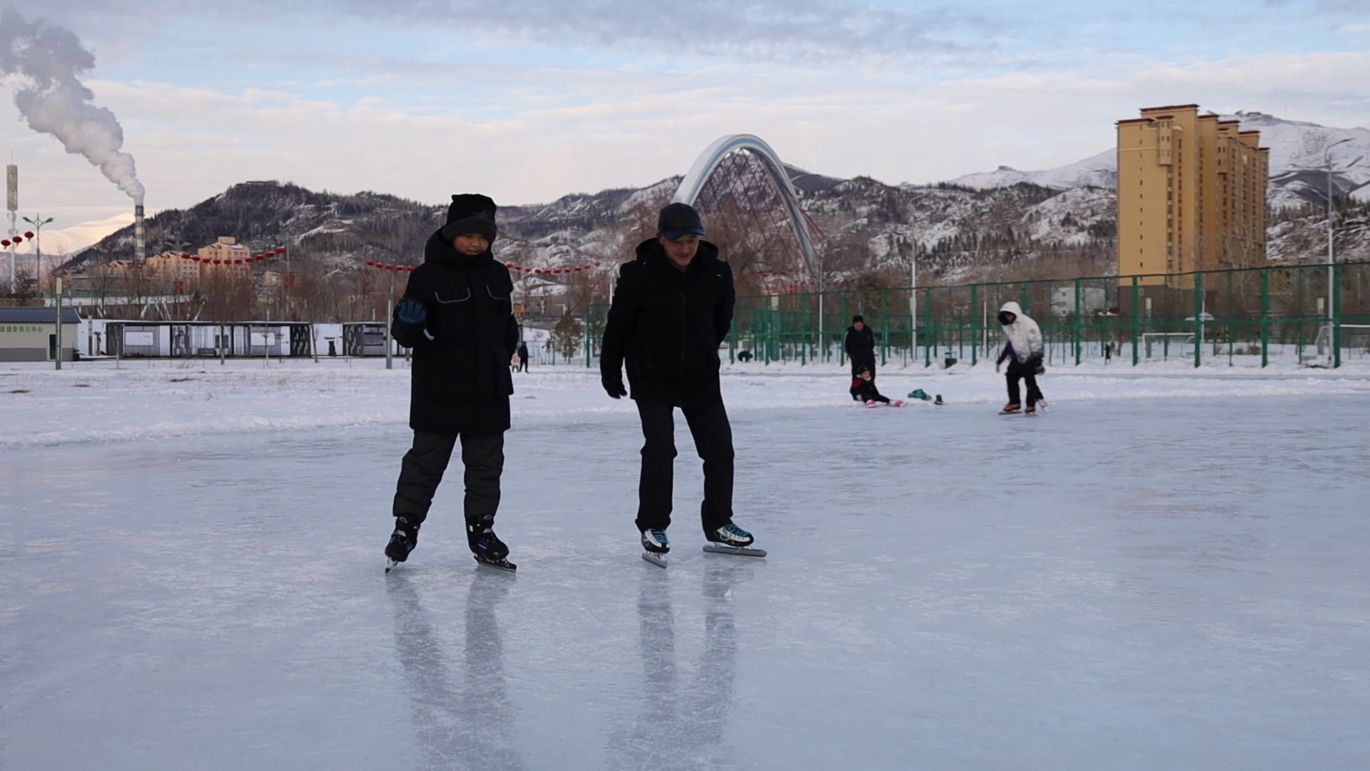 在滑冰场内,市民正带领孙子一同滑冰。